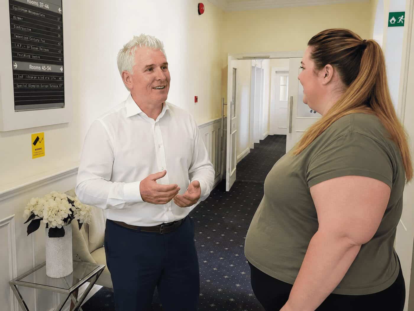 A consultant greeting a patient in the hallway