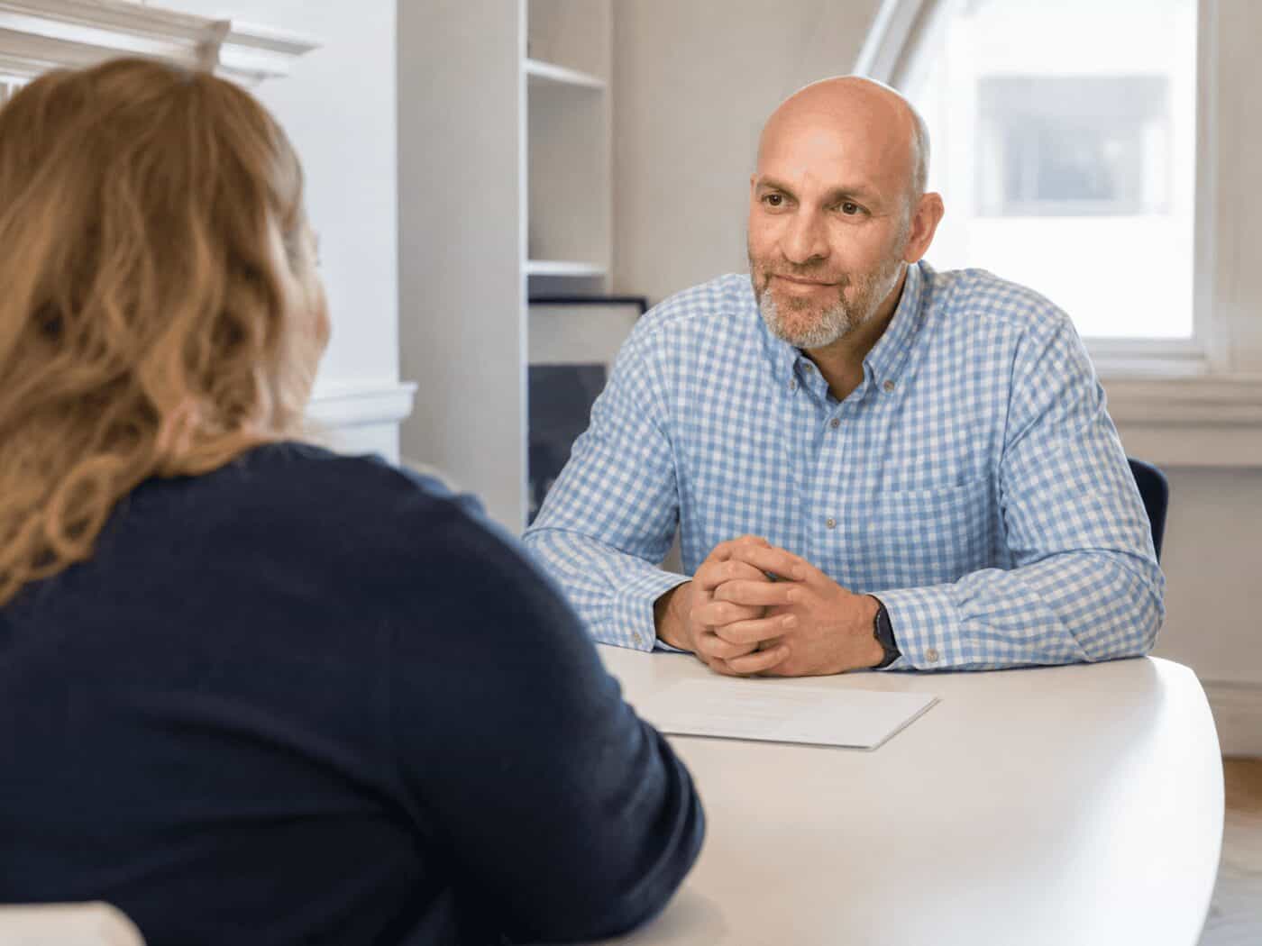 A consultant and patient in conversation across the table